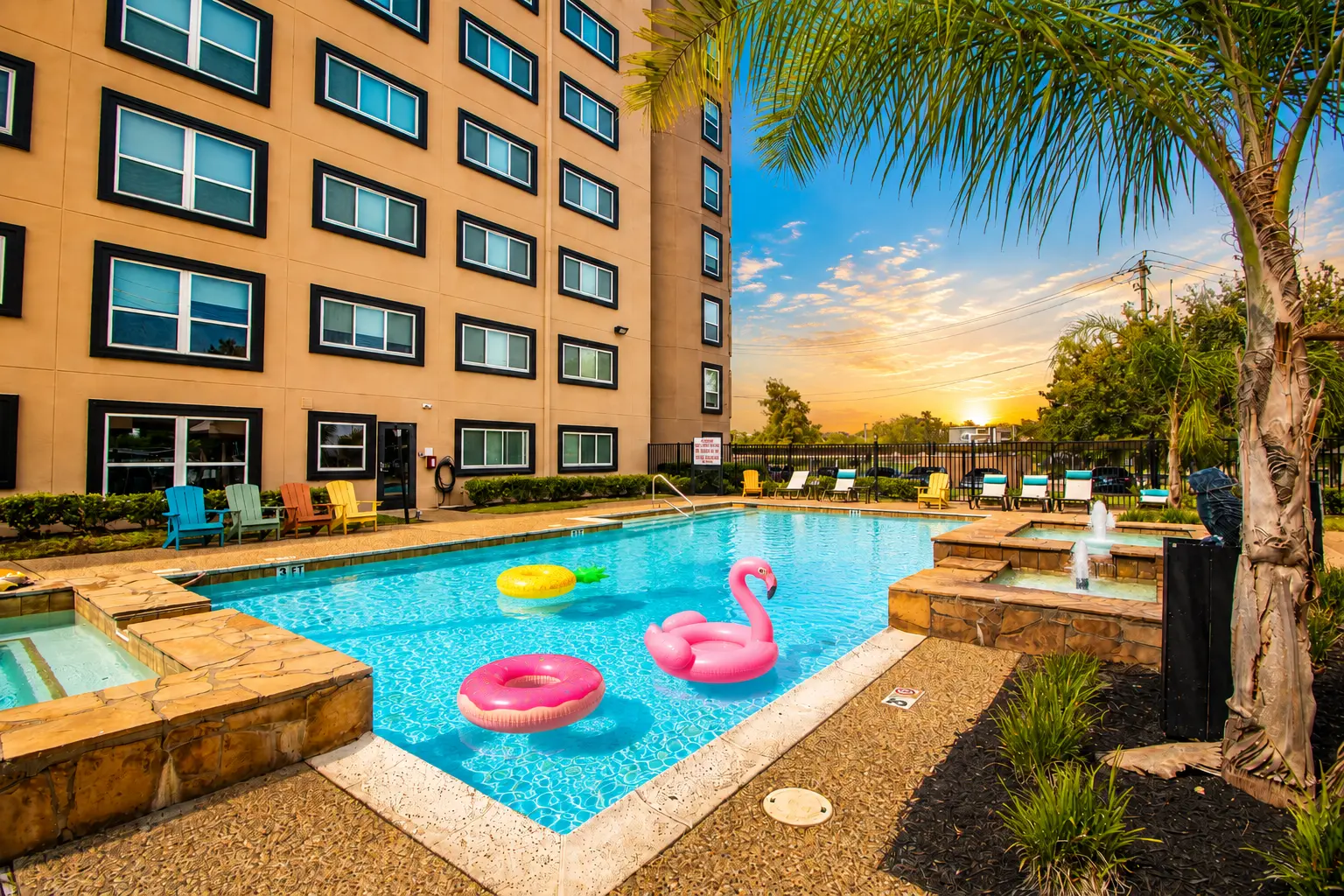 Multifamily community pool and amenities at sunset